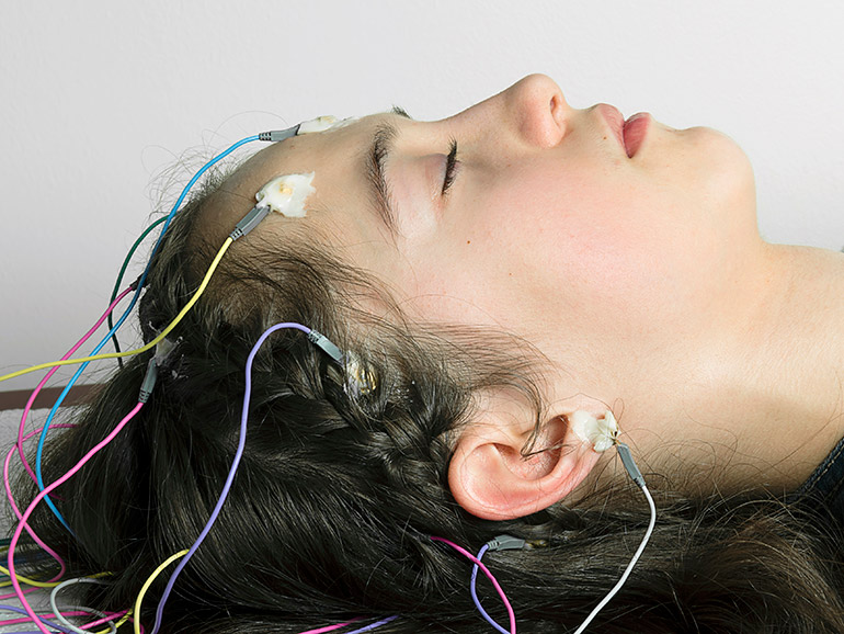 Woman sleeping with electrodes